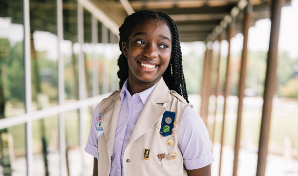 Girl smiling wearing Girl Scout vest
