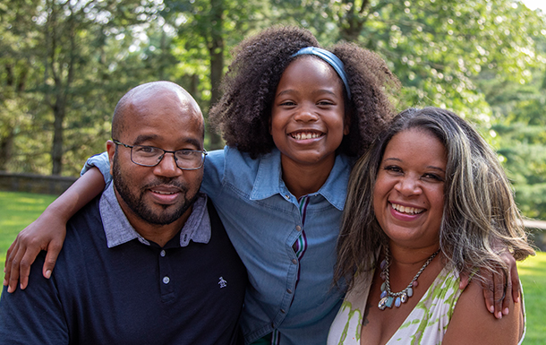 mom and dad with young daughter